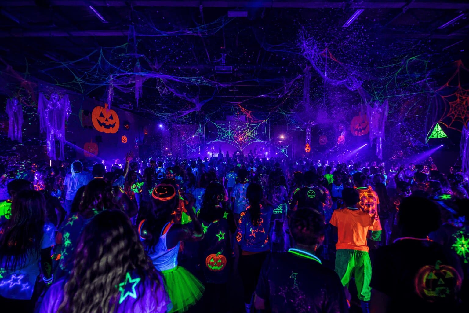 Halloween black light party with pumpkins and decor